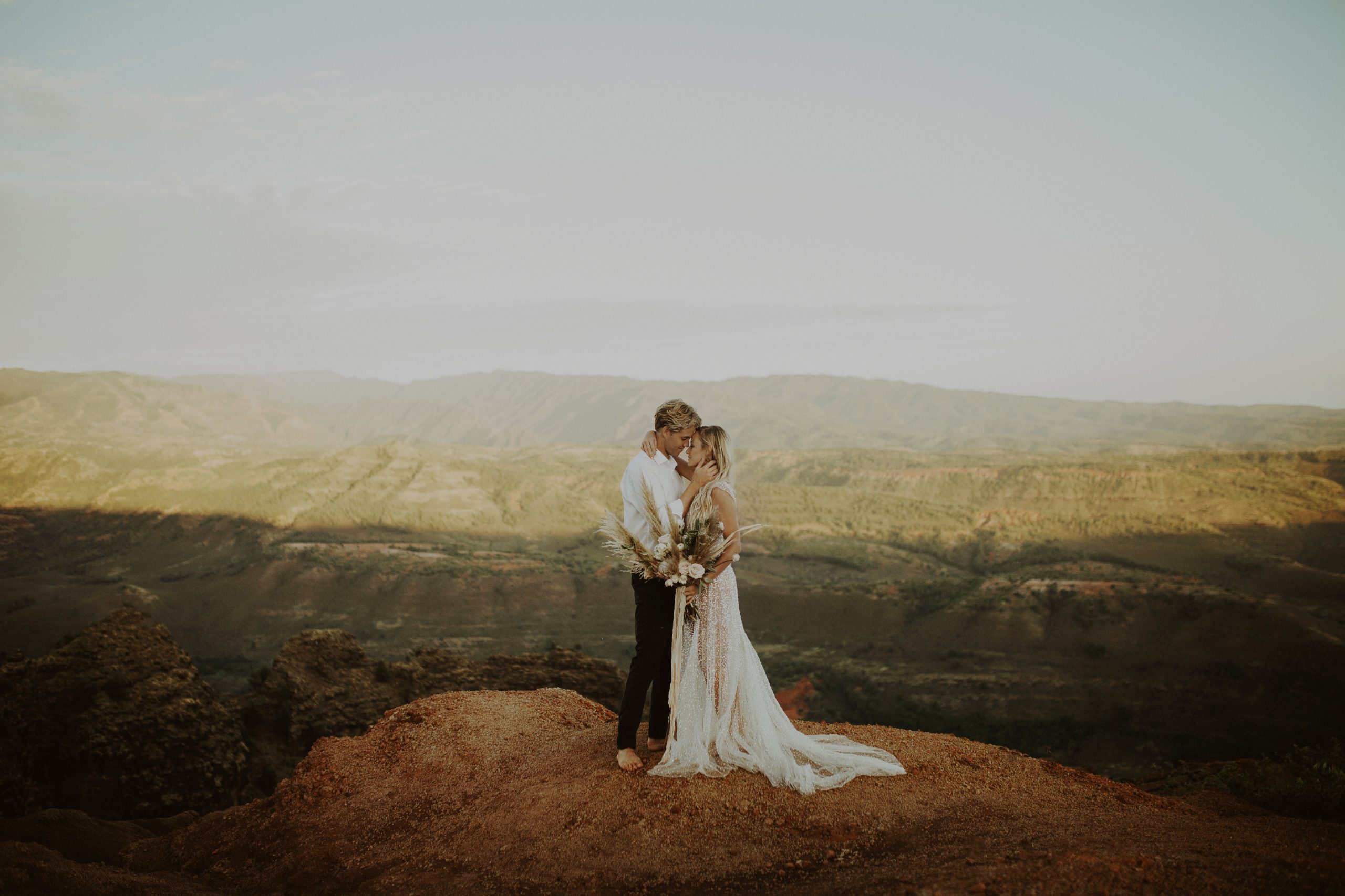 Bride and groom hug at Waimea Canyon during their Kauai elopement