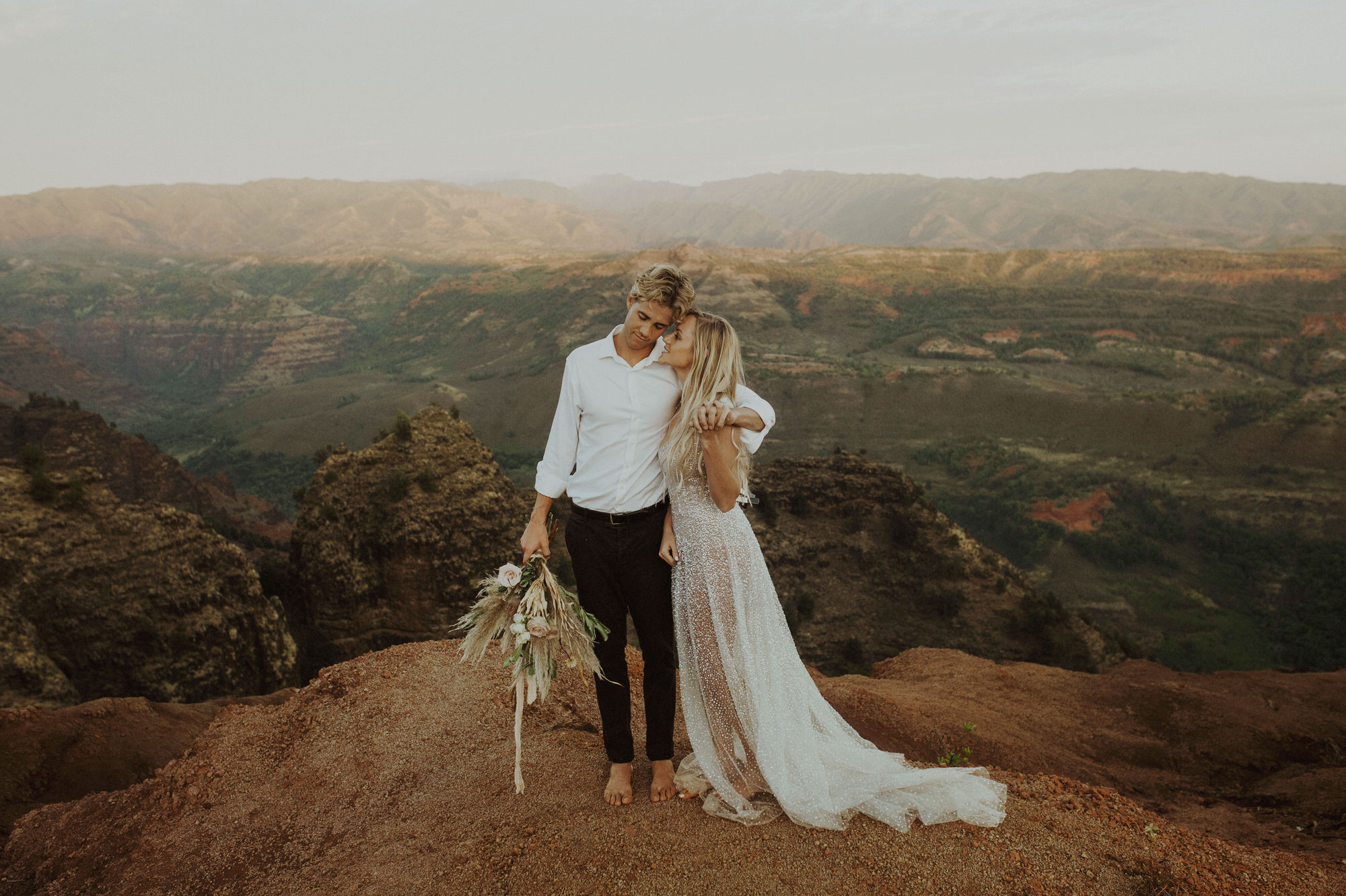 Bride and groom hug at Waimea Canyon during their Kauai elopement