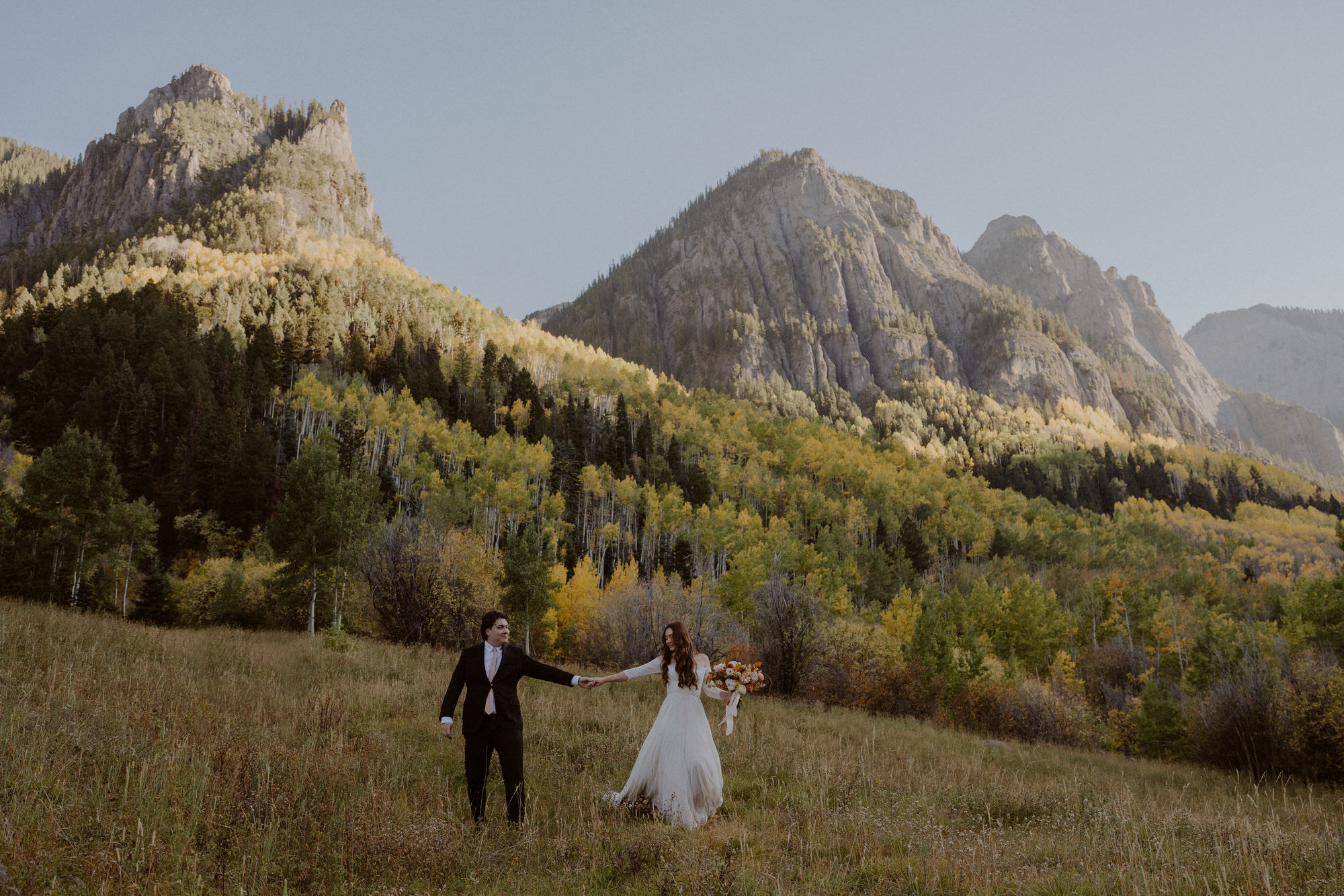 Couple walks through Colorado Mountains