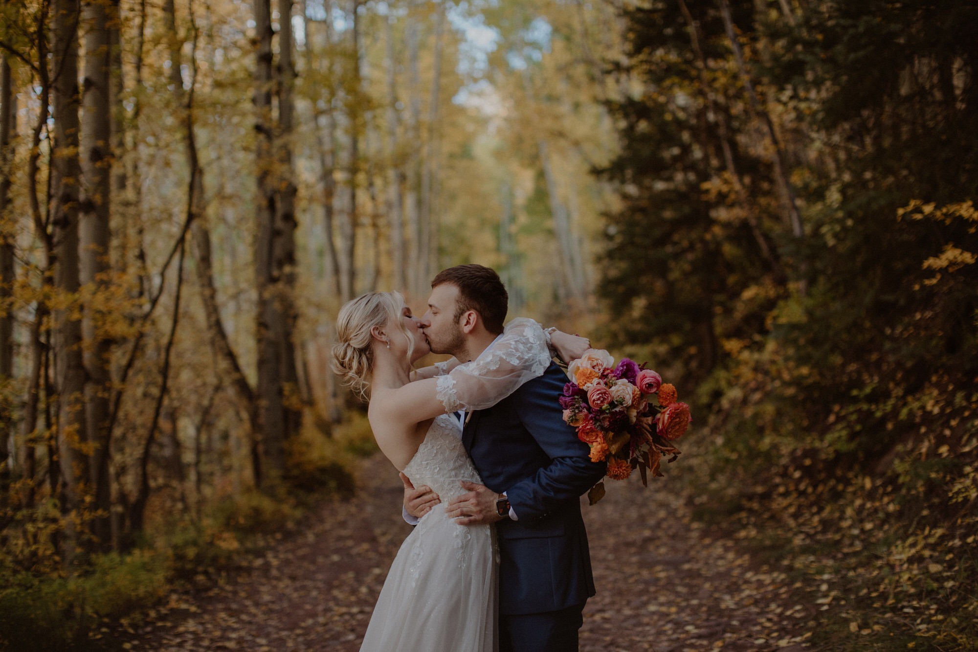 Couple kisses during their fall Colorado elopement
