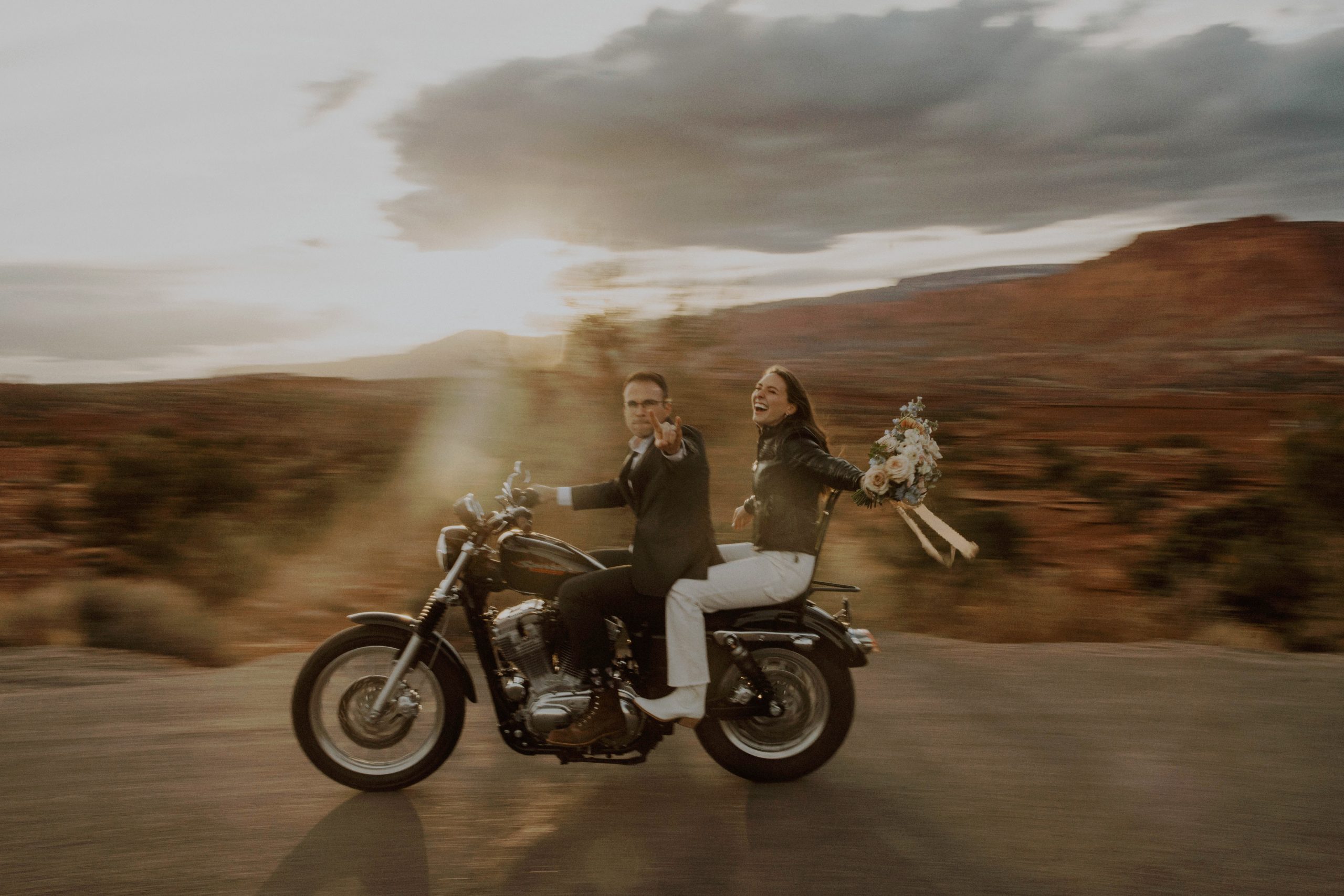 Couple rides a motorcycle during their Moab, Utah elopement